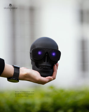 skull speaker in holding in hand