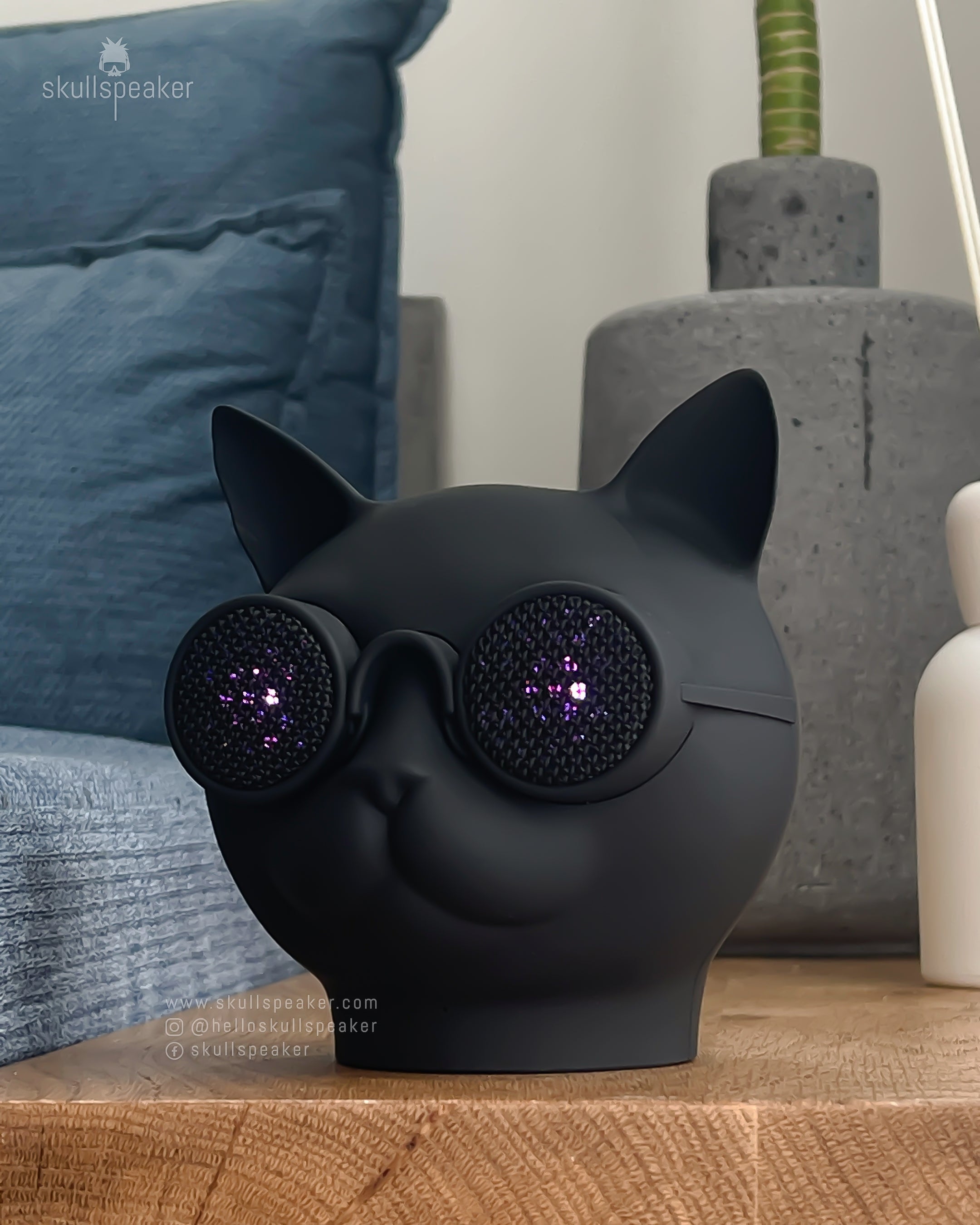 cat speaker purrrfect standing on counter with lights on